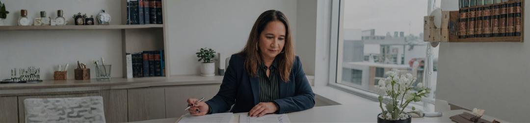 An Australian online business owner working through a legal document checklist at a desk.