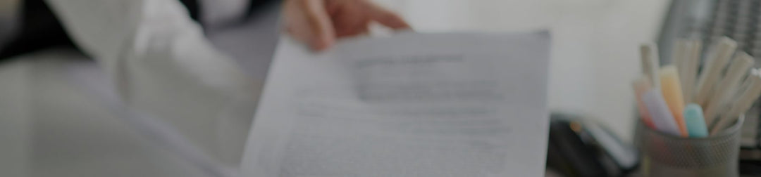 Female founder handing an employee a contract in a bright office 